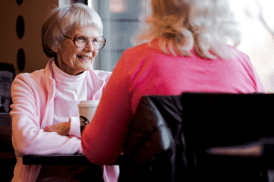 Two elderly women chatting warmly.